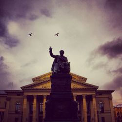 Low angle view of statue against cloudy sky