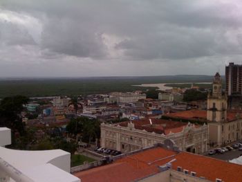 Cityscape against cloudy sky