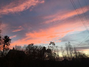 Silhouette trees against sky during sunset