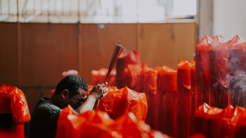 Man holding incense at temple