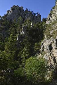 Low angle view of rocks on mountain against sky