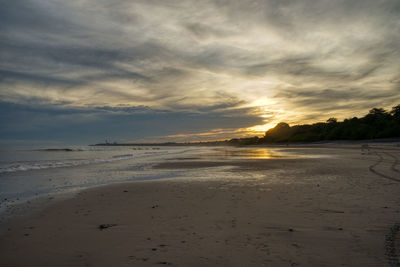 Scenic view of beach against sky during sunset