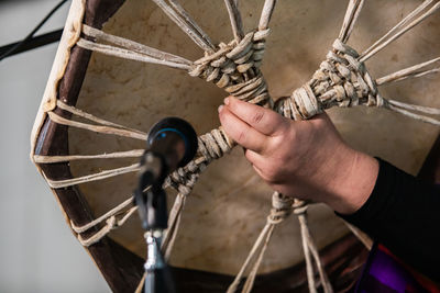 Close-up of man holding rope tied to boat