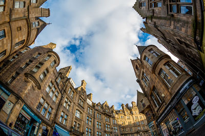 Low angle view of buildings against cloudy sky