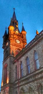 Low angle view of clock tower against blue sky