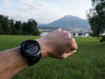 Cropped hand of man holding navigational compass