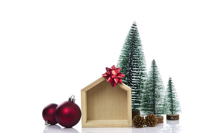 Christmas decorations on tree against white background