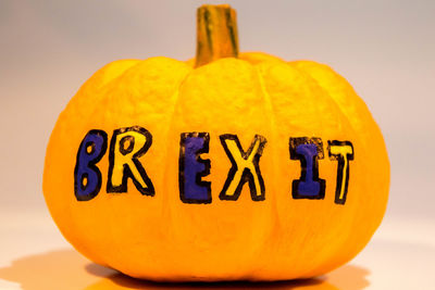 Close-up of pumpkin against yellow background