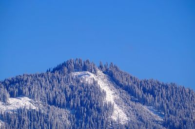 Scenic view of snowcapped mountains against clear blue sky