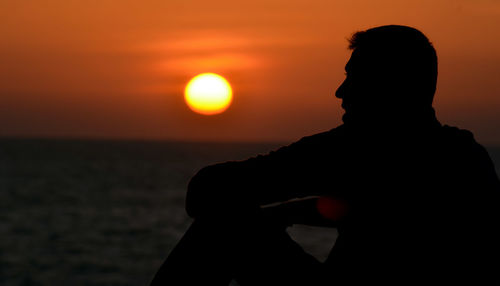 Silhouette of people at sunset