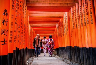 People walking in temple outside building