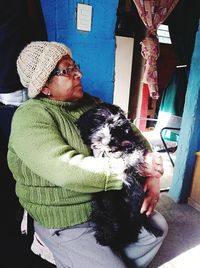 Portrait of man with dog at home