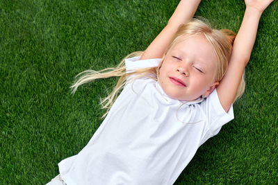 High angle view of young woman standing on grassy field