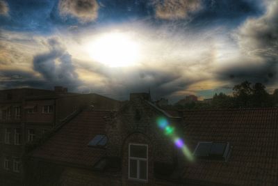 Buildings against cloudy sky