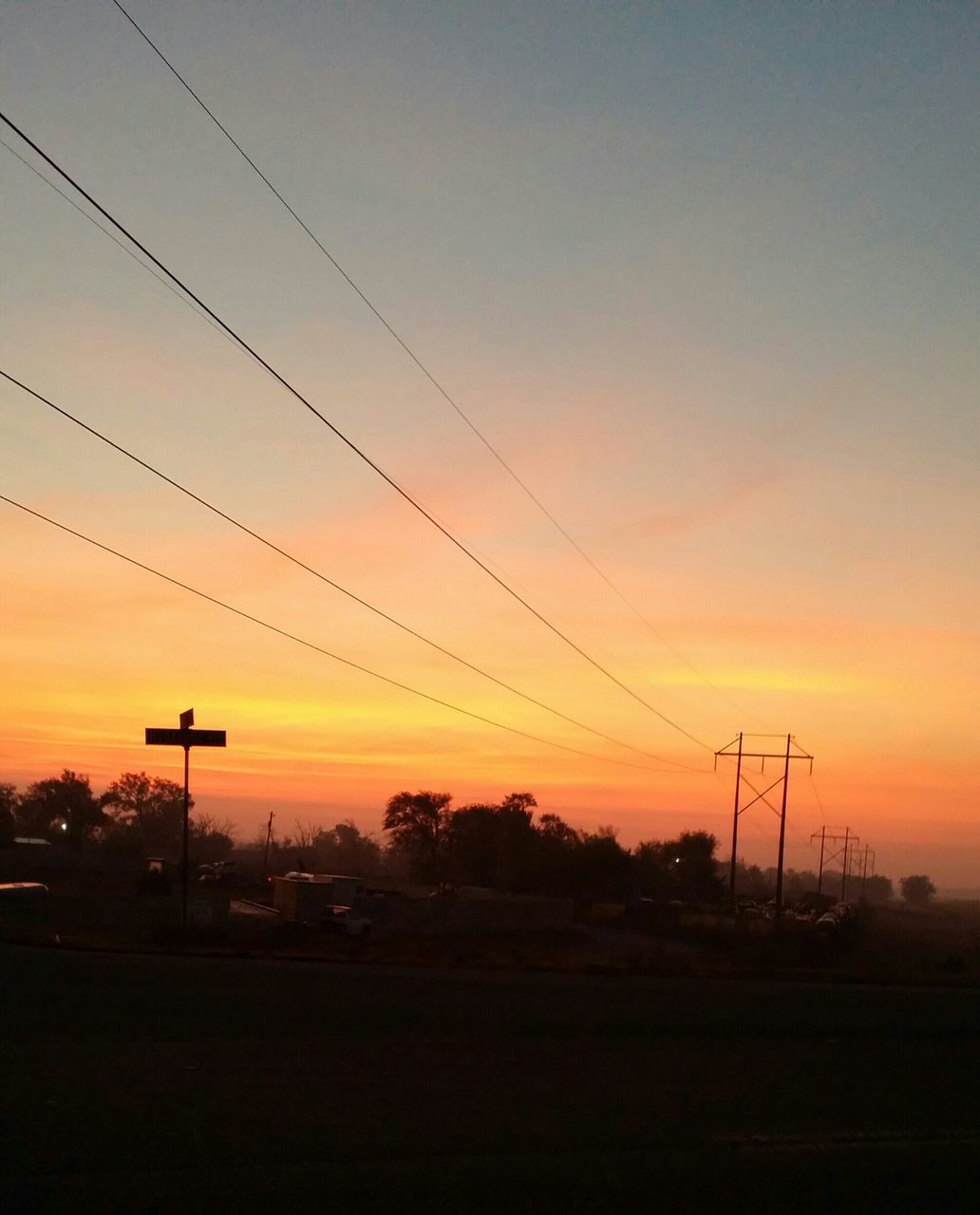 sunset, silhouette, power line, electricity pylon, orange color, sky, electricity, tranquility, tree, beauty in nature, scenics, fuel and power generation, power supply, connection, nature, cable, tranquil scene, landscape, technology, street light