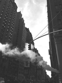 Low angle view of buildings against cloudy sky