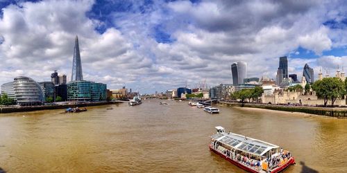 Boats in river with buildings in background