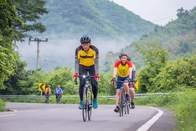 People riding bicycle on road