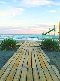 Scenic view of swimming pool by sea against sky