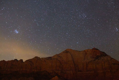 Scenic view of mountains against sky at night