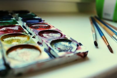 Close-up of multi colored pencils on table