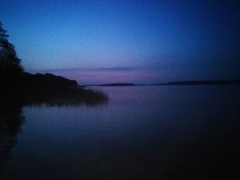 Scenic view of lake against sky at sunset