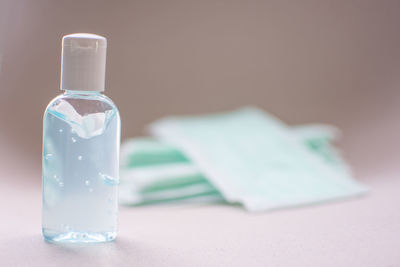 Close-up of wineglass on table against white background