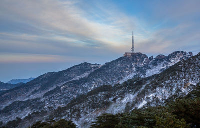 Low angle view of mountain against cloudy sky