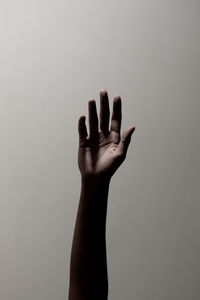 Close-up of hand against gray background