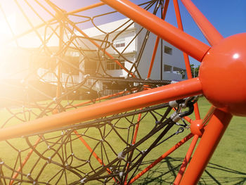 Close-up of chain swing ride against sky