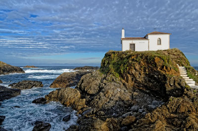 House by sea against sky