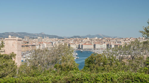 Buildings against clear blue sky