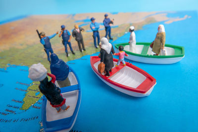 People on boat in sea against blue sky
