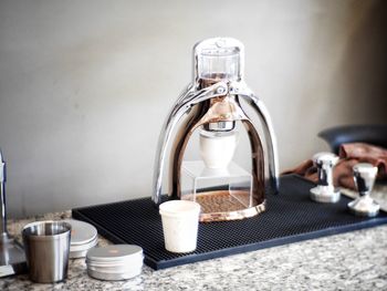 Close-up of coffee maker on table