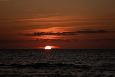 Scenic view of sea against romantic sky at sunset