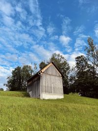 Built structure on field against sky