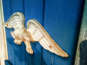 View of eagle decoration on blue door