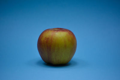 Close-up of apple against blue background