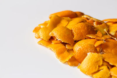 Close-up of orange fruit against white background