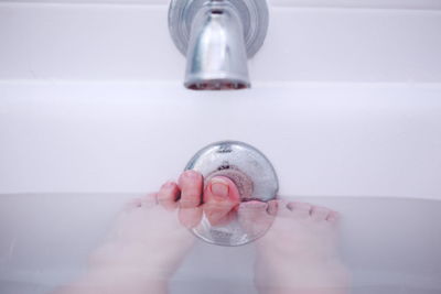 Low section of woman in bath tub