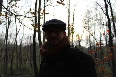 Portrait of man wearing sunglasses against trees