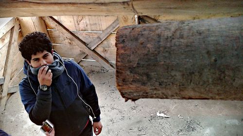 Man looking at log indoors