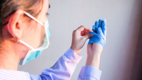 Midsection of woman holding hand gloves