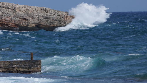 Sea waves splashing on rocks