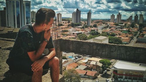 Portrait of man with cityscape in background