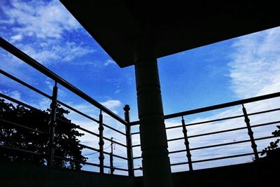 Low angle view of silhouette trees against blue sky