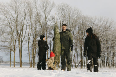 Family with christmas tree at winter