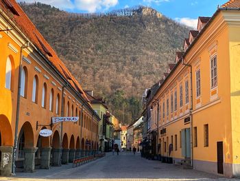 Street amidst buildings in city against sky