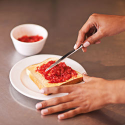 Cropped hands of person preparing food