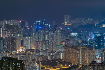 Illuminated cityscape against sky at night